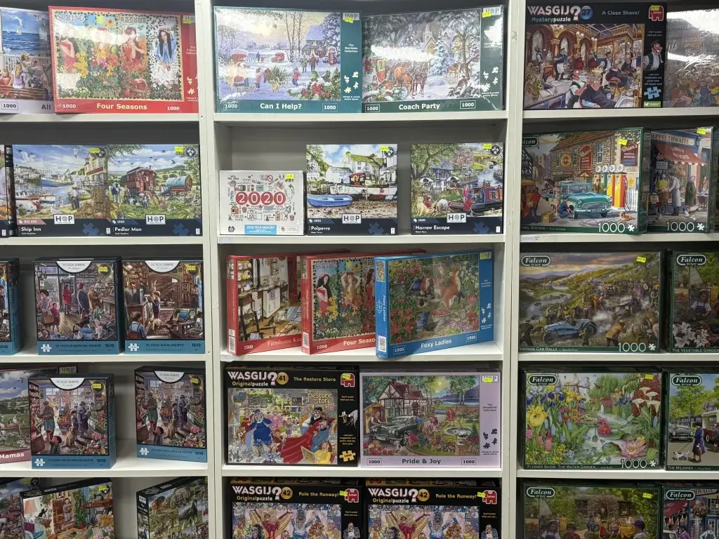 Colorful craft kits showcasing various designs like tigers, princesses, and zebras, displayed on a retail wall.