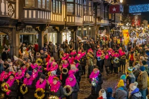 Crowds of People talking part in a parade in Chester
