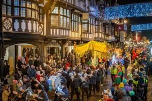 Crowds of People talking part in a parade in Chester