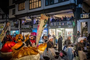 Crowds of People talking part in a parade in Chester