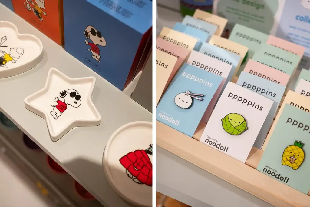 A display of playful merchandise featuring Snoopy-themed dishes and colorful pins designed by Noodoll.