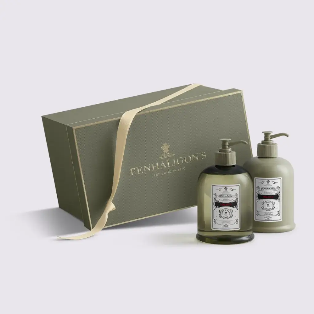Elegant green gift box from Penhaligon's containing two luxurious pump bottles of scented products.