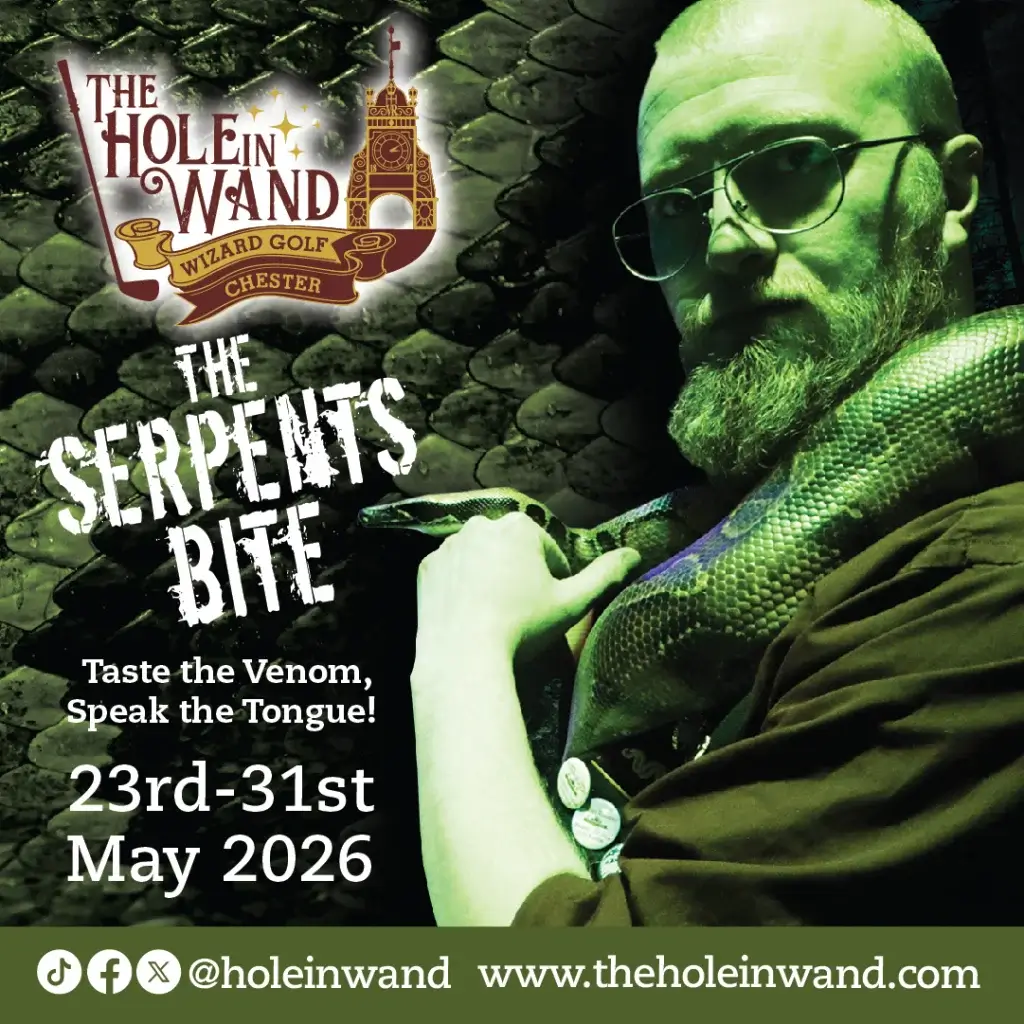 Bearded man with glasses holding a large green snake beside the Hole in Wand logo and text "The Serpent's Bite", 23–31 May 2026.