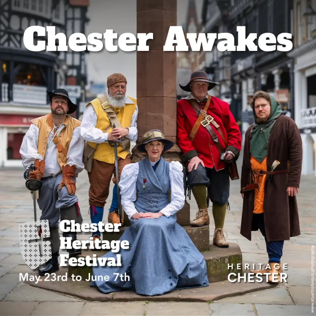 Five people in historical costume posed around a stone market cross promoting the Chester Heritage Festival.